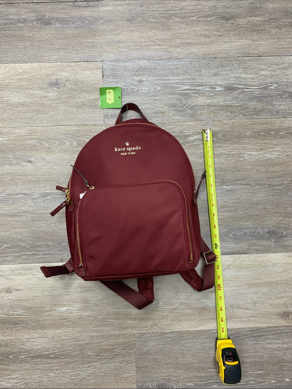 kate spade burgundy nylon backpack with gold-tone accents